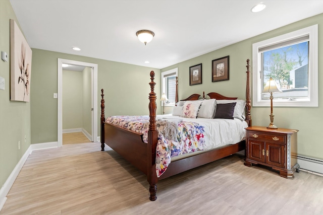 1385 Front St, Manchester, NH 03102 - bedroom featuring light wood finished floors, multiple windows, baseboards, recessed lighting, and a baseboard heating unit