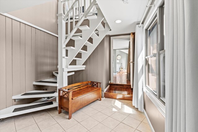 1385 Front St, Manchester, NH 03102 - staircase featuring tile patterned floors and wood walls