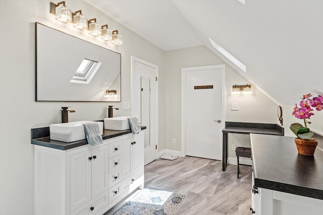 1385 Front St, Manchester, NH 03102 - full bathroom featuring a skylight, lofted ceiling, and double vanity