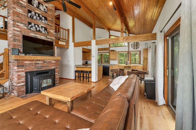living room with wooden ceiling, light wood-type flooring, beamed ceiling, and high vaulted ceiling