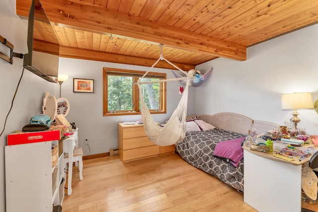 bedroom featuring wood ceiling, beamed ceiling, light wood-type flooring, and baseboard heating