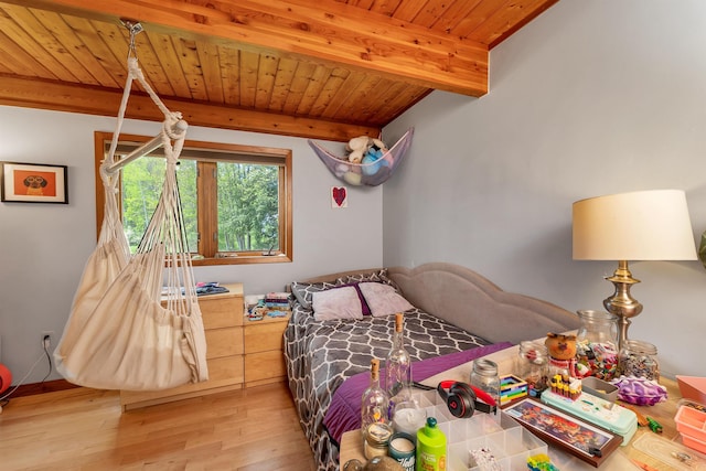 bedroom featuring beam ceiling, wooden ceiling, and light wood-type flooring