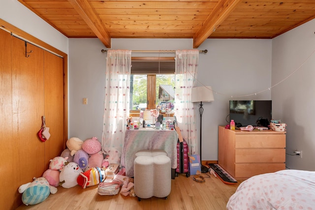 bedroom featuring beamed ceiling, wood ceiling, and hardwood / wood-style flooring