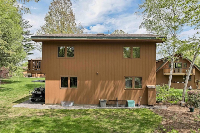 rear view of house featuring a yard