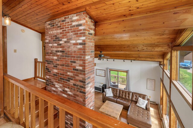 living area featuring wooden ceiling, a ceiling fan, and light wood-type flooring
