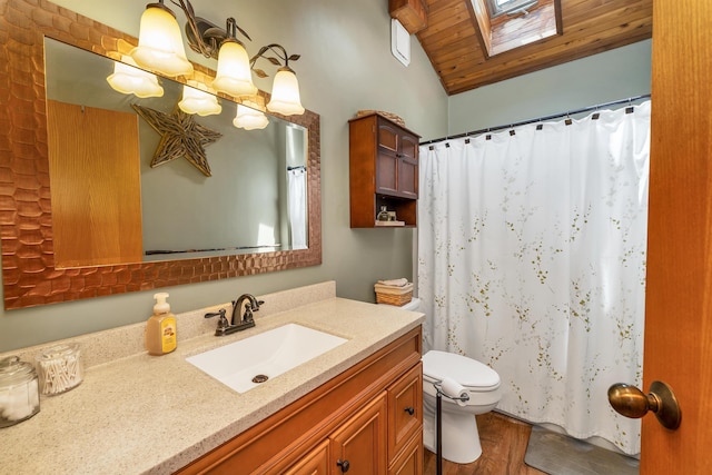 full bathroom featuring toilet, lofted ceiling, vanity, wooden ceiling, and a skylight