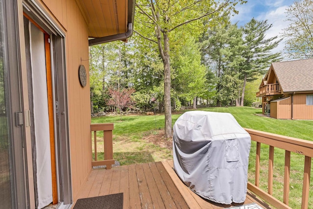 wooden terrace featuring a yard