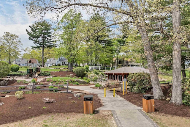 surrounding community featuring fence and view of scattered trees