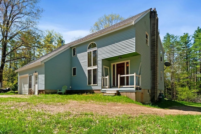 back of property with an attached garage