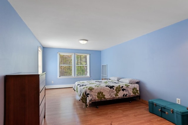 bedroom featuring wood finished floors and baseboards