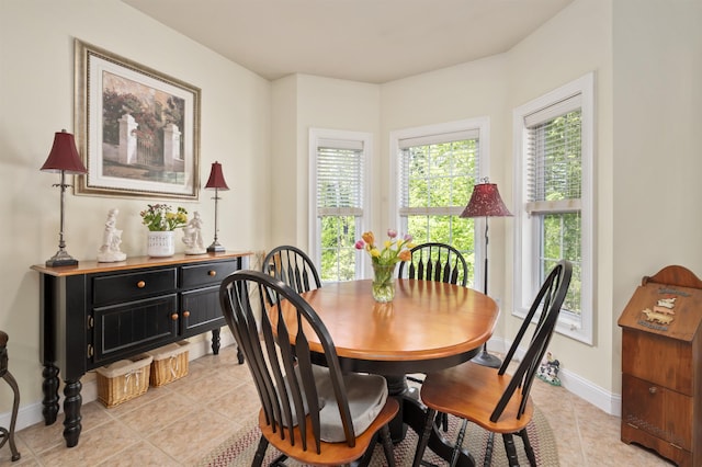 dining space with light tile patterned floors and baseboards