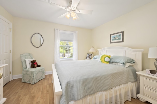 bedroom featuring light wood-type flooring, baseboards, and a ceiling fan