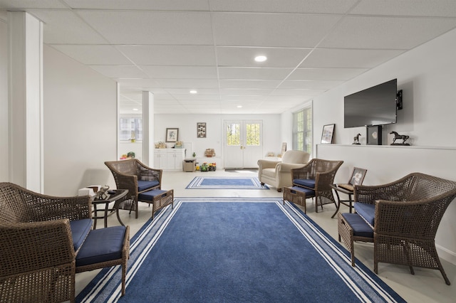 sitting room with a drop ceiling and recessed lighting