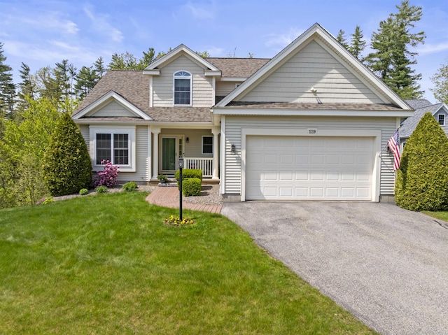 traditional-style house with driveway, an attached garage, roof with shingles, and a front yard