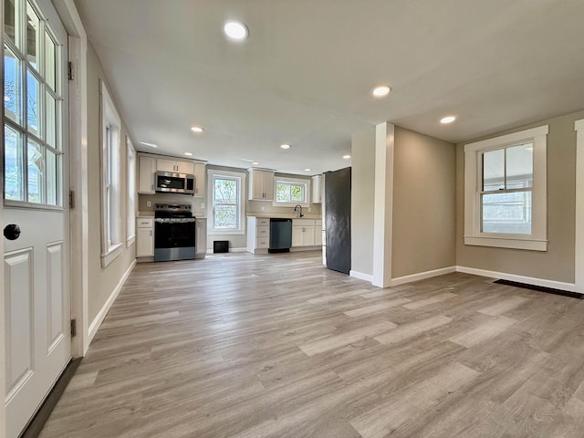 516 Hall St, Bow, NH 03304 - unfurnished living room featuring light wood finished floors, baseboards, a sink, and recessed lighting