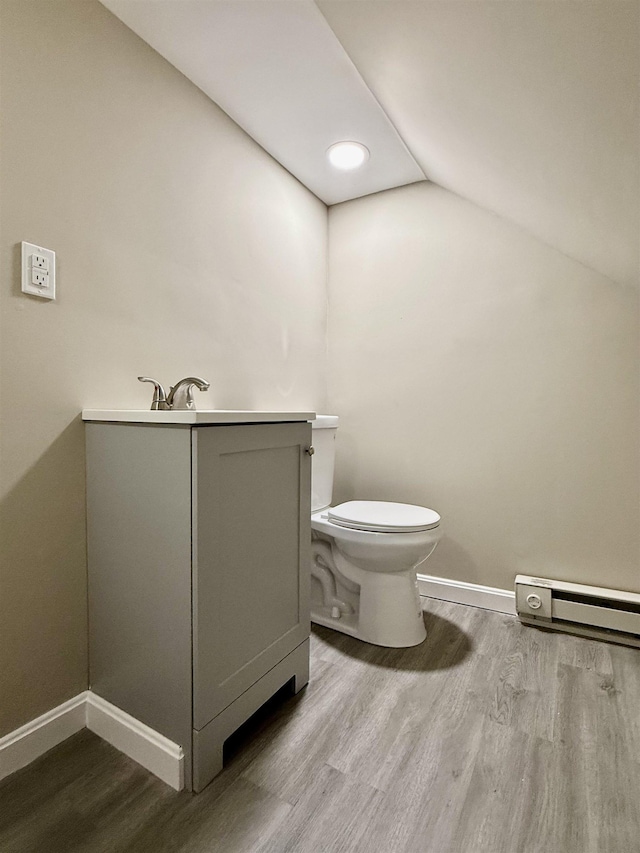 516 Hall St, Bow, NH 03304 - half bathroom featuring wood finished floors, baseboards, lofted ceiling, toilet, and baseboard heating