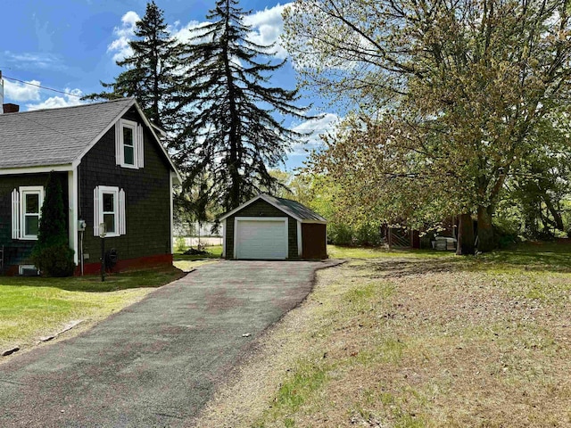 516 Hall St, Bow, NH 03304 - view of property exterior featuring a detached garage, an outdoor structure, driveway, a yard, and a chimney