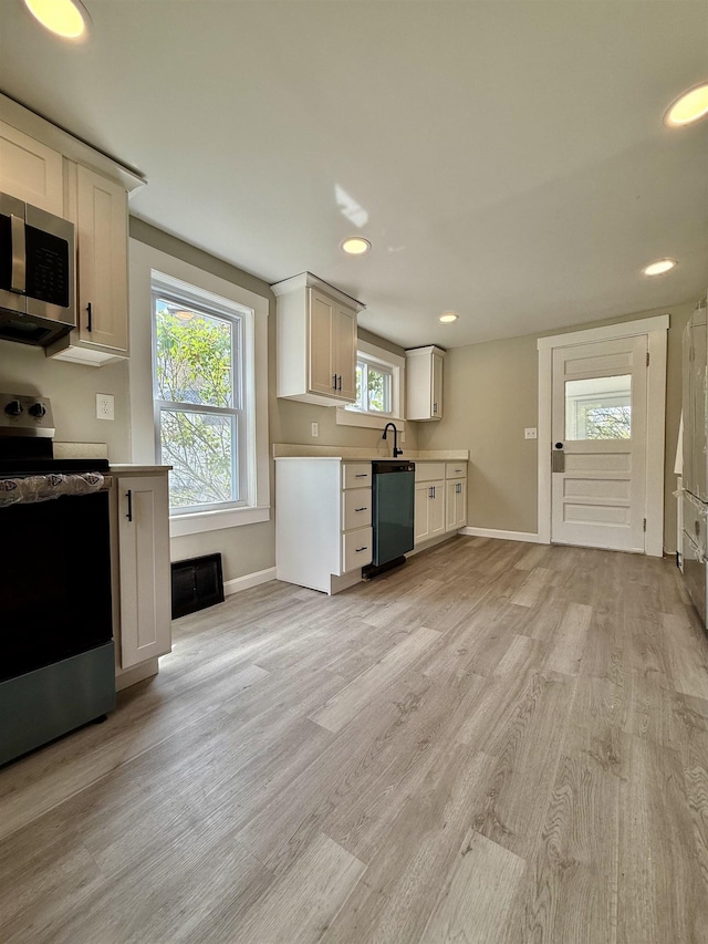516 Hall St, Bow, NH 03304 - kitchen featuring stainless steel appliances, light wood-style floors, baseboards, light countertops, and recessed lighting