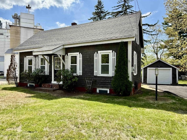516 Hall St, Bow, NH 03304 - view of front of home with an outbuilding, asphalt driveway, a shingled roof, a detached garage, and a front yard