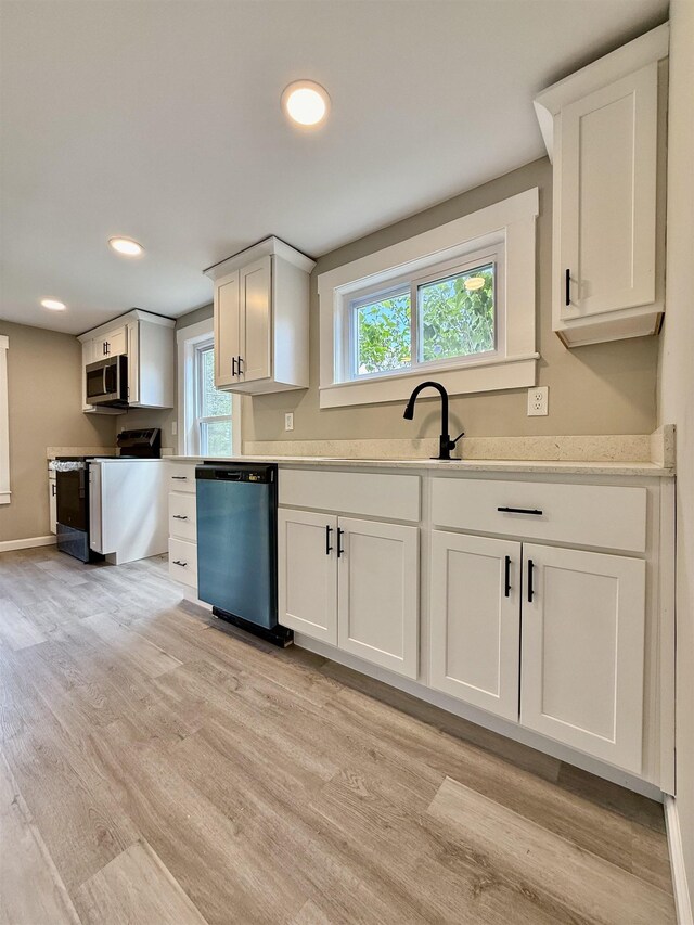 516 Hall St, Bow, NH 03304 - kitchen with dishwasher, stainless steel microwave, electric range, light countertops, and light wood-style floors