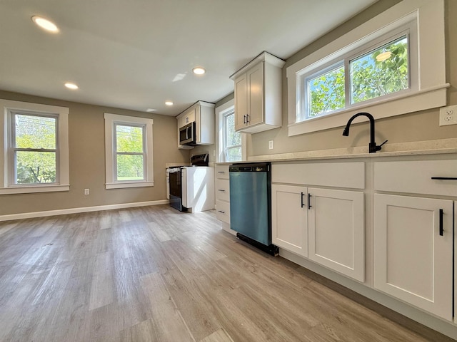 516 Hall St, Bow, NH 03304 - kitchen featuring dishwasher, stove, stainless steel microwave, light wood-style flooring, and a sink