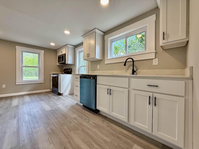 516 Hall St, Bow, NH 03304 - kitchen featuring range with electric stovetop, dishwashing machine, light countertops, stainless steel microwave, and light wood-type flooring