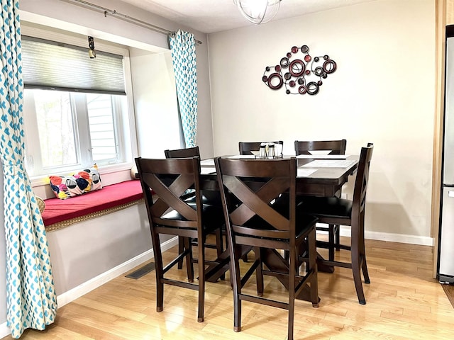 dining room featuring wood finished floors and baseboards