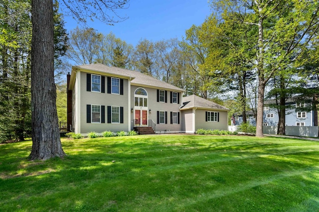 colonial-style house with a front lawn and entry steps