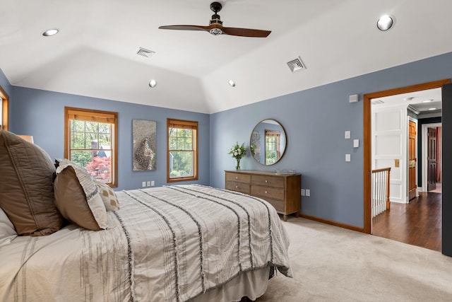 carpeted bedroom featuring vaulted ceiling, recessed lighting, baseboards, and ceiling fan