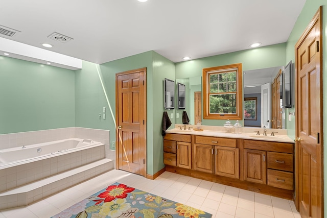bathroom featuring tile patterned flooring, a bath, double vanity, and recessed lighting
