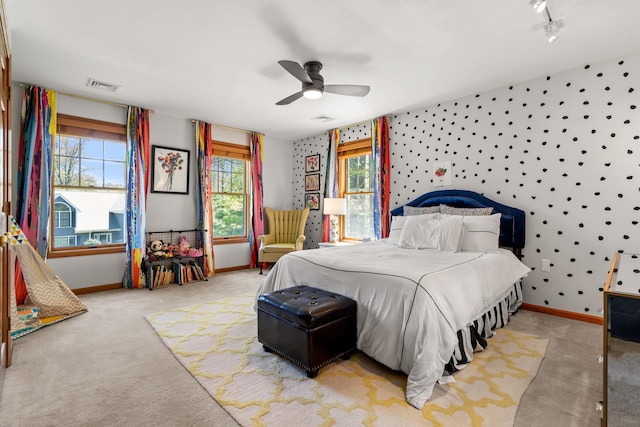 bedroom featuring carpet flooring, baseboards, a ceiling fan, and rail lighting