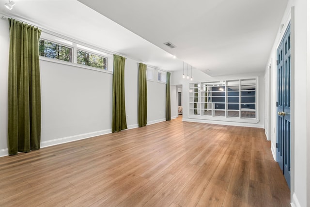 empty room with light wood-type flooring and baseboards