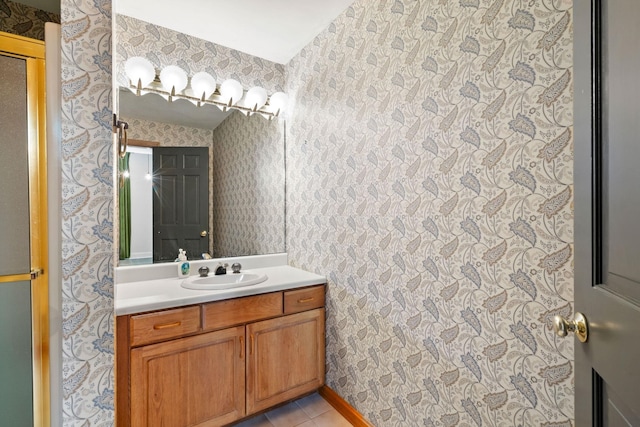 bathroom with wallpapered walls, vanity, and tile patterned floors