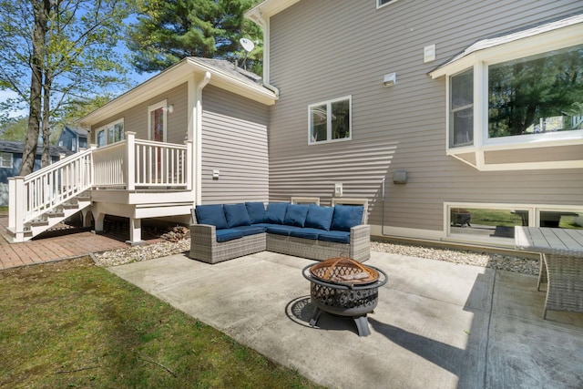 view of patio with an outdoor living space with a fire pit