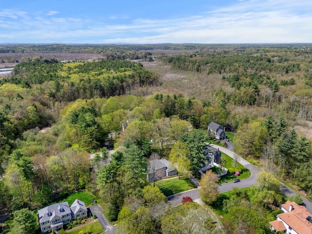 aerial view of property and surrounding area with a forest