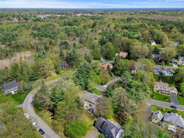 aerial overview of property's location with a heavily wooded area and nearby suburban area