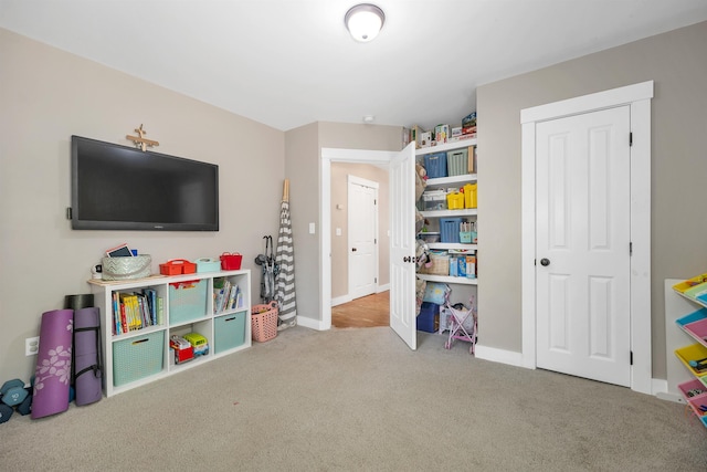 game room featuring carpet floors and baseboards