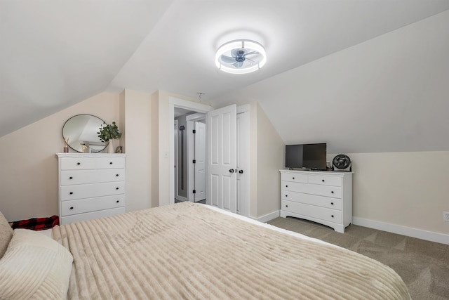 bedroom featuring lofted ceiling, carpet flooring, and baseboards