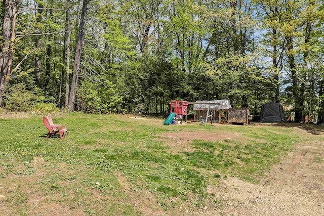 view of grassy yard featuring a playground