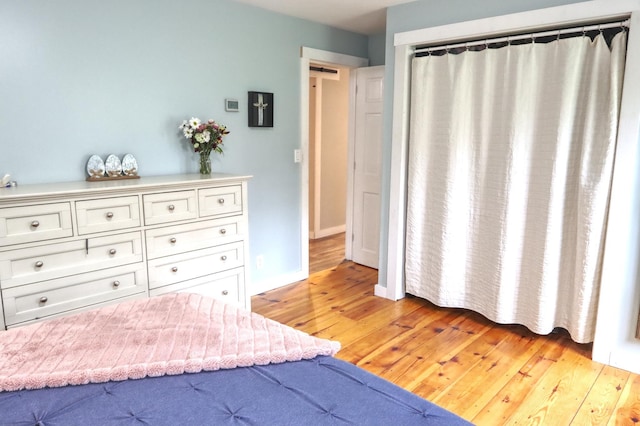 bedroom with light wood-style floors and baseboards