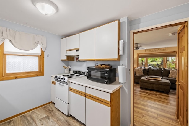 kitchen featuring white electric stove, black microwave, under cabinet range hood, light countertops, and light wood finished floors
