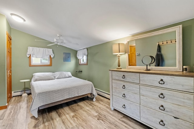 bedroom featuring a baseboard heating unit, light wood finished floors, a ceiling fan, electric panel, and lofted ceiling