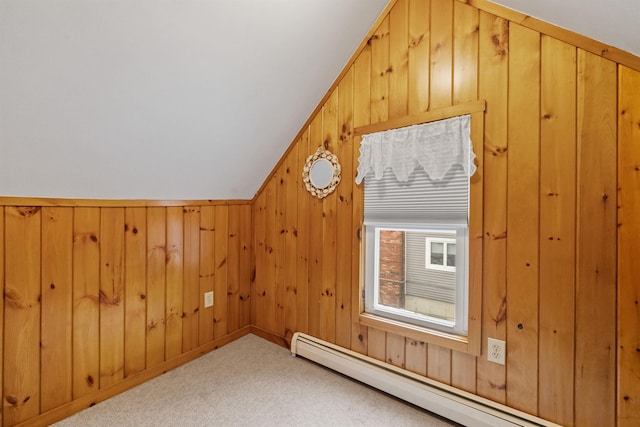 bonus room with baseboard heating, carpet, and wooden walls