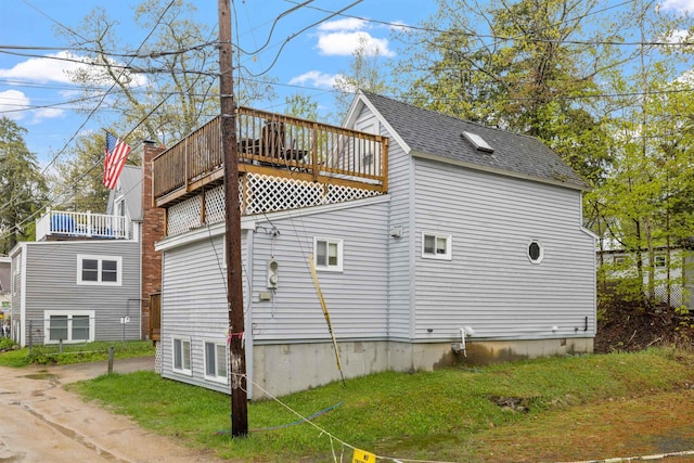 view of side of property with a shingled roof