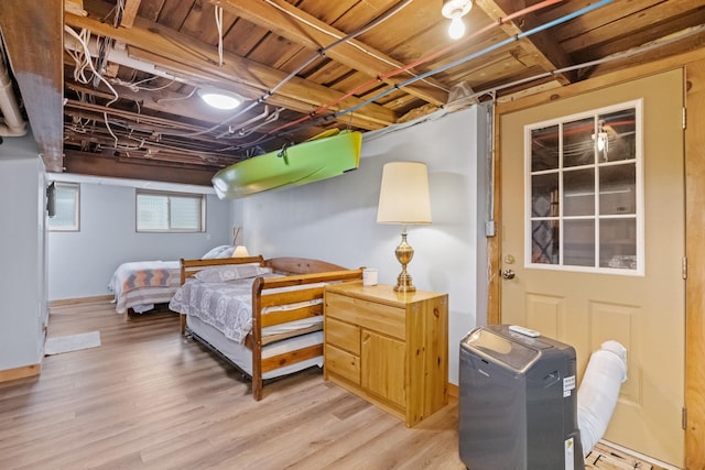 bedroom featuring light wood finished floors and baseboards