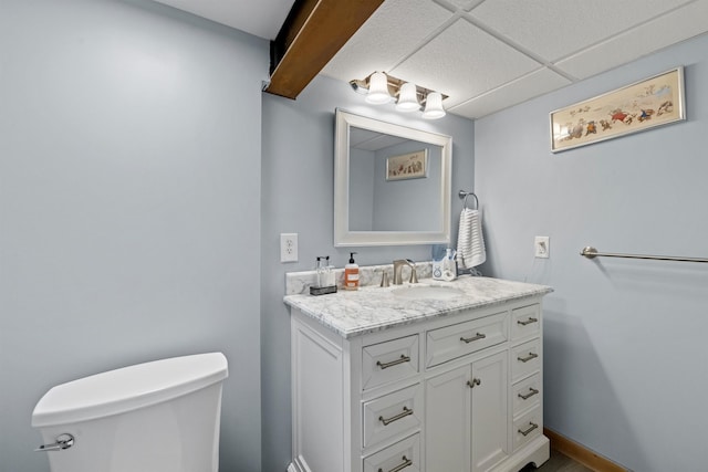 half bathroom with vanity and toilet