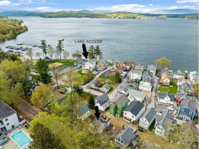 view of property location featuring a nearby body of water and nearby suburban area