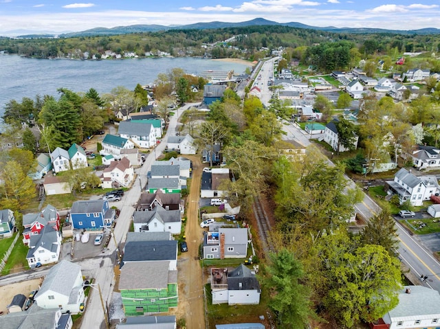 aerial view of property's location featuring nearby suburban area and a water and mountain view