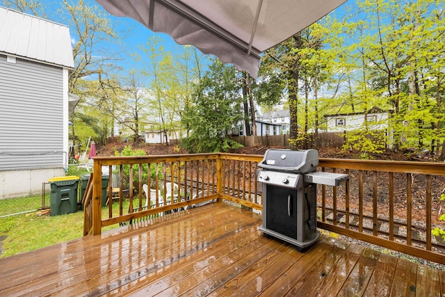 wooden deck with area for grilling and fence
