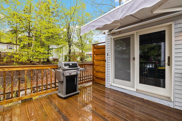 wooden terrace featuring a grill